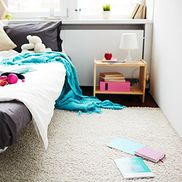 A teenages carpeted bedroom